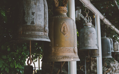 ritual Buddhist bells in the tourist places of Asia close-up. Buddhism in Thailand