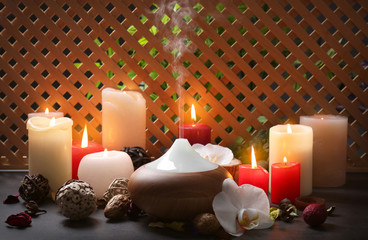 Aroma lamp and candles on table