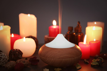 Aroma lamp and candles on table