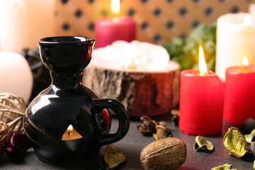Aroma lamp and candles on table