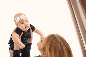 Fototapeta premium Young mother with her baby at home