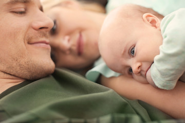 Portrait of young parents with cute baby