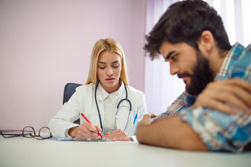 Fototapeta premium Female counselor writing down some information about her patient.