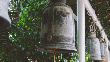 ritual Buddhist bells in the tourist places of Asia close-up. Buddhism in Thailand