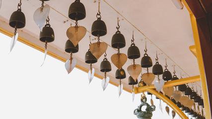 ritual Buddhist bells in the tourist places of Asia close-up. Buddhism in Thailand