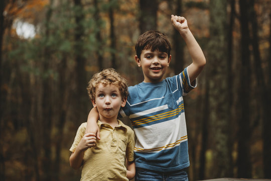 Portrait of boy with brother standing at park