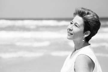 Portrait of beautiful 45 years old woman walking on seaside