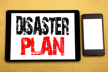 Hand writing text caption inspiration showing Disaster Plan. Business concept for Emergency Recovery Written on tablet laptop, wooden background with sticky note, coffee and pen