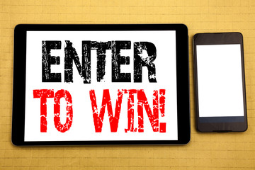 Hand writing text caption inspiration showing Enter to Win. Business concept for Winning in Competition Written on tablet laptop, wooden background with sticky note, coffee and pen