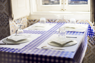 Table in traditional Portuguese restaurant ready for four people