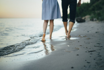 couple is walking on the seaside holding hands