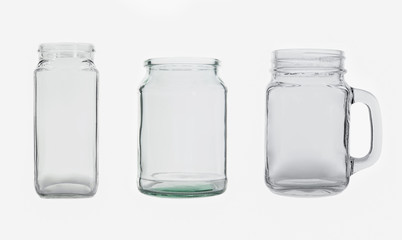 Tree empty glass jars isolated on white background.