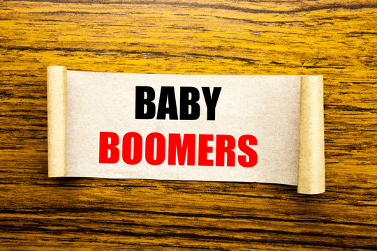 Hand writing text caption inspiration showing Baby Boomers. Business concept for Demographic Generation written on sticky note paper on the wooden background.