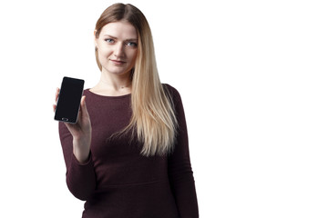 Fototapeta premium Portrait of a smiling cute woman showing blank smartphone screen isolated on a white background