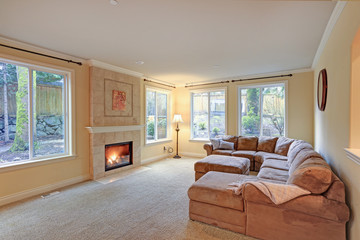 Spacious light living room features classic fireplace