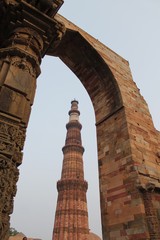 New Delhi, India - October 2014: Qutub minar, new delhi framed in a stone gate