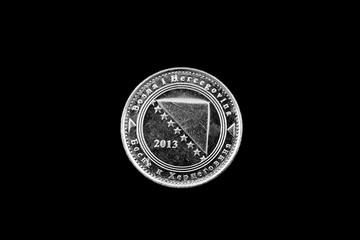 A macro image of a Bosnian 5 fenings coin isolated on a black background