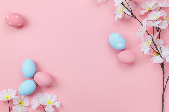 Top view aerial image of decoration & symbol Happy Easter holiday background concept.Flat lay accessory bunny eggs & floral on modern beautiful pink paper at home office desk.Free space for design.