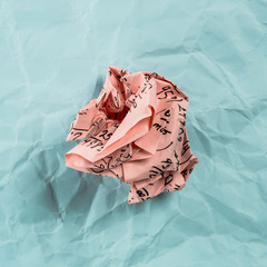 Crumpled multi colored paper balls with mathematical equations on multi colored plain paper, with...