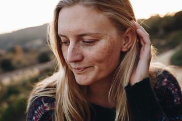 Beautiful Blonde pulling hair behind her ear