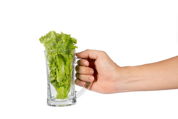 lettuce green in glass water in a hand isolated   on white background.