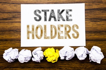 Word, writing Stake Holders. Concept for Stakeholder Engagement Written on sticky note paper reminder, wooden background with sticky, one folded paper alone for difference or collaboration