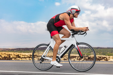 Triathlon cyclist man cycling racing on road bike on ironman competition racing against time....