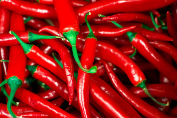 Red peppers background texture of hot red chili, seasoning paprika, fiery red hot in the kitchen a dish of red pepper for sale