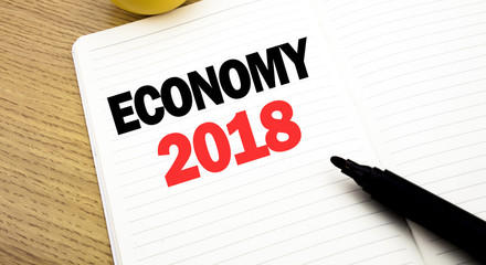 Conceptual hand writing text caption inspiration showing Economy 2018. Business concept for Word  finance Future Plan written on notebook, copy space on book background with marker pen