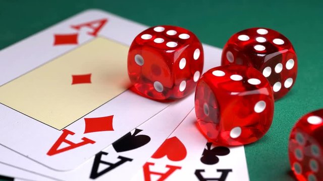 red dice on the game table with cards and chips to play