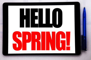 Fototapeta premium Conceptual hand writing text caption inspiration showing Hello Spring!. Business concept for Summer Time Welcoming written on tablet computer on the white background with pen in the office.