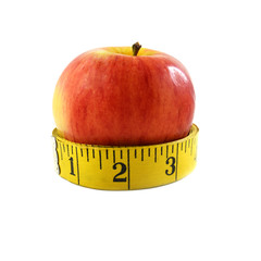 Red apple fruit and tape measure isolated on white background