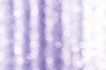 Abstract blurred light bokeh on purple background, festive season concept background