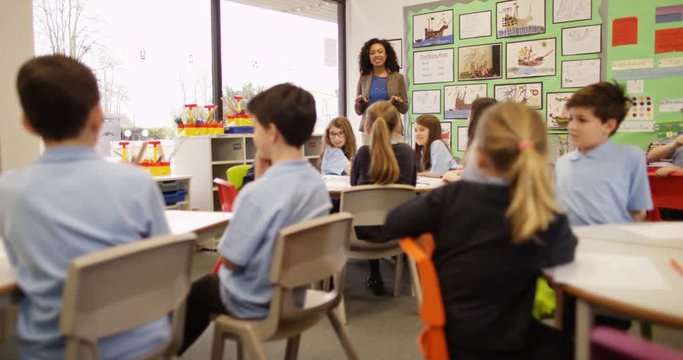 4K Elementary School Teacher Talking To Class Of Young Children & Asking Questions. Slow Motion