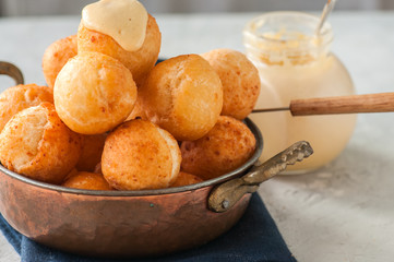 Small cottage cheese doughnuts (castgnole) served in a vintage bowl. Festive dessert.