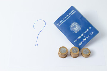 Brazilian work document and social security document (carteira de trabalho) with money as a concept of how little money the worker make - question mark as a question of job  on white background