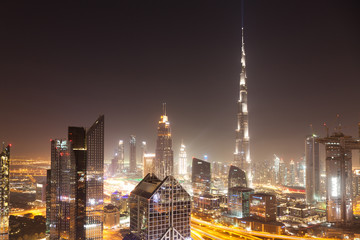 Fototapeta premium DUBAI, UAE - FEBRUARY 2018: Dubai skyline at sunset with Burj Khalifa, the world tallest building and Sheikh Zayed road traffic