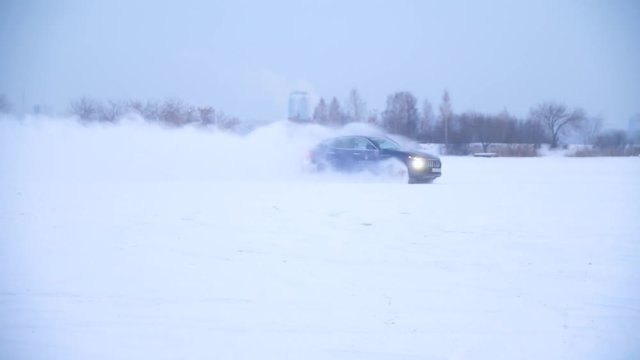 Sliding on an ice line. Snow drifting. DRIVING IN THE SNOW. Sport car racing on snow race track in winter. Driving a race car on a snowy road.