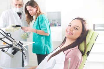 Happy female patient at the dental office