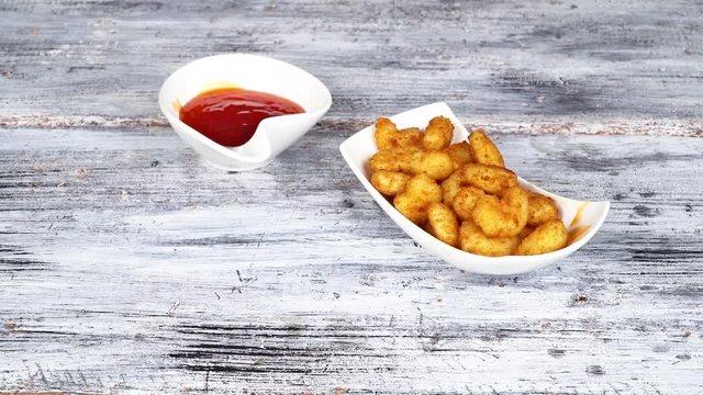 Close-up Dish of shrimp on a plate being served in restaurant by waiter in gloves.