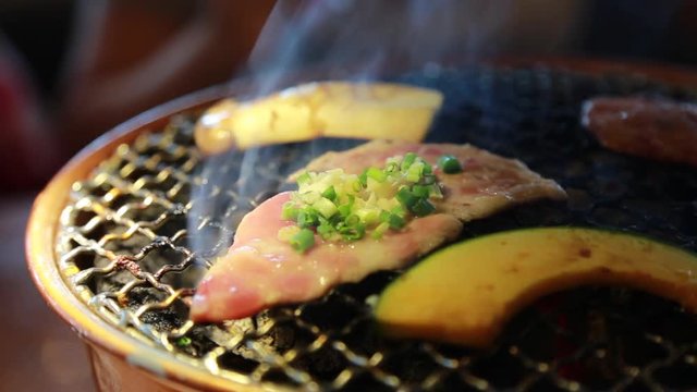 barbeque pork mush room and vegetable on steel net with hot coal with smoke
