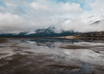 Reflective flooded fields show the Canadian Rockies of Jasper National Park