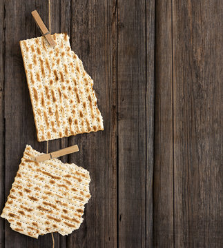 Two pieces of matzah or matza on a vintage wood background with copy space or text space. Perfect for your Passover design