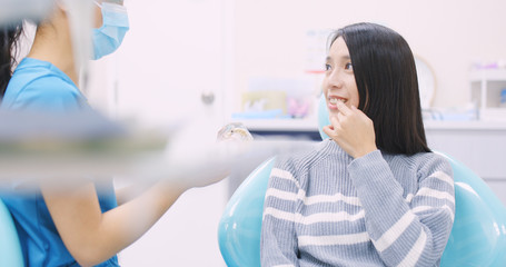 Dentist explaining the implant tooth to the patient