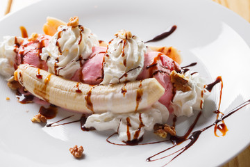 Banana split ice cream with whipped , nuts and cherry