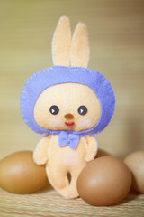 Easter rabbittoy with eggs in the chaff background