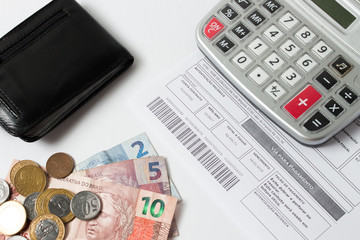 Concept of controlling spending at home or business  - calculator - money - bills 