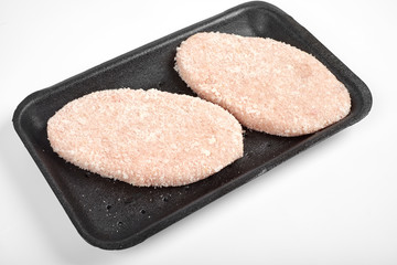 raw delicious chicken cutlet in package. Isolated on a white background.