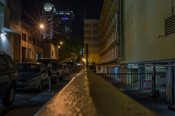 busy alley in the city lights after dark