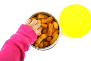 Baby hand reaching for crunch baked snack in the container